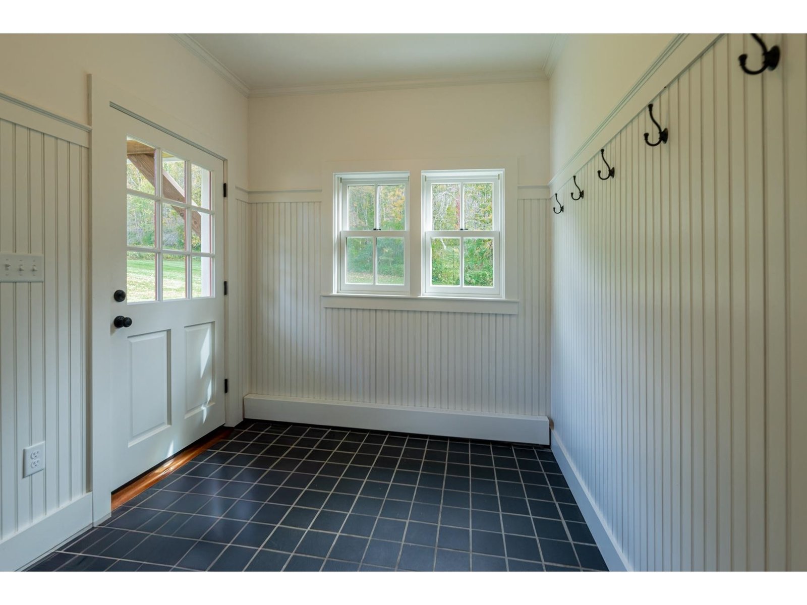 Large mud room with both pegs and closet