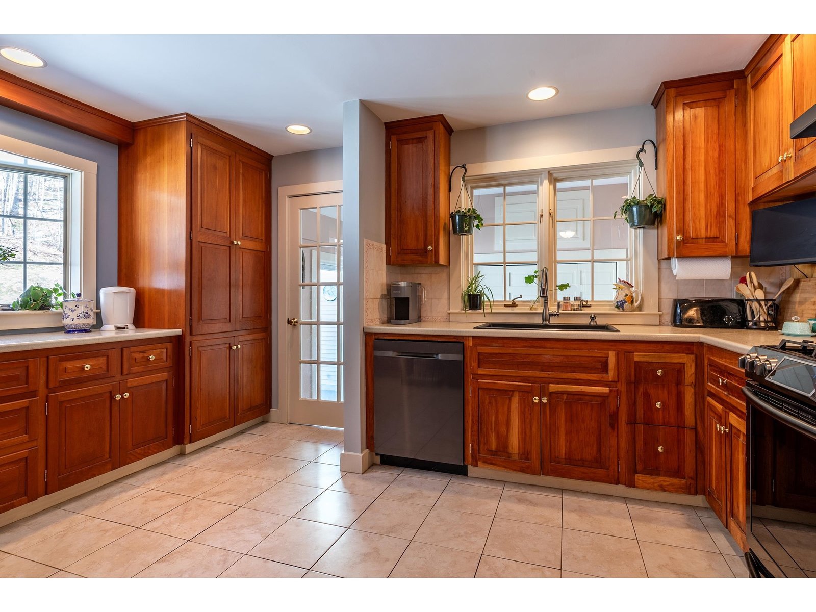 A bright kitchen with cherry cabinets