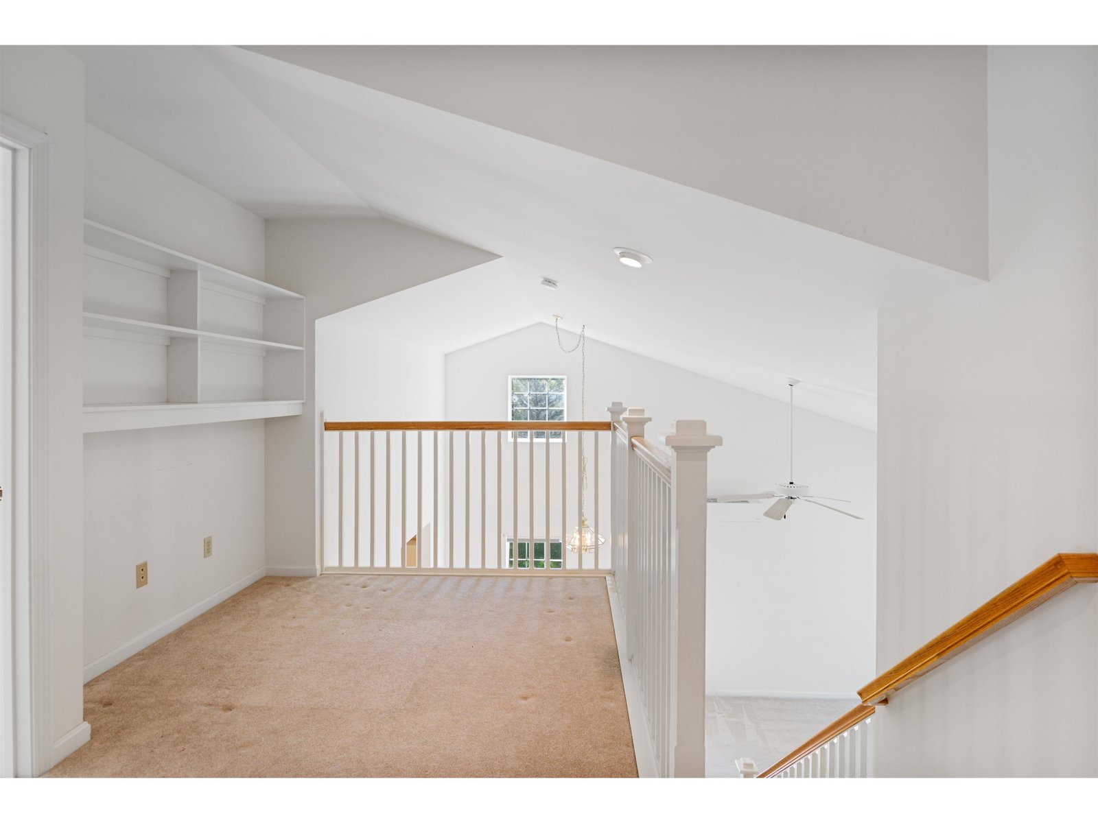 Second floor landing with bookshelves & closet