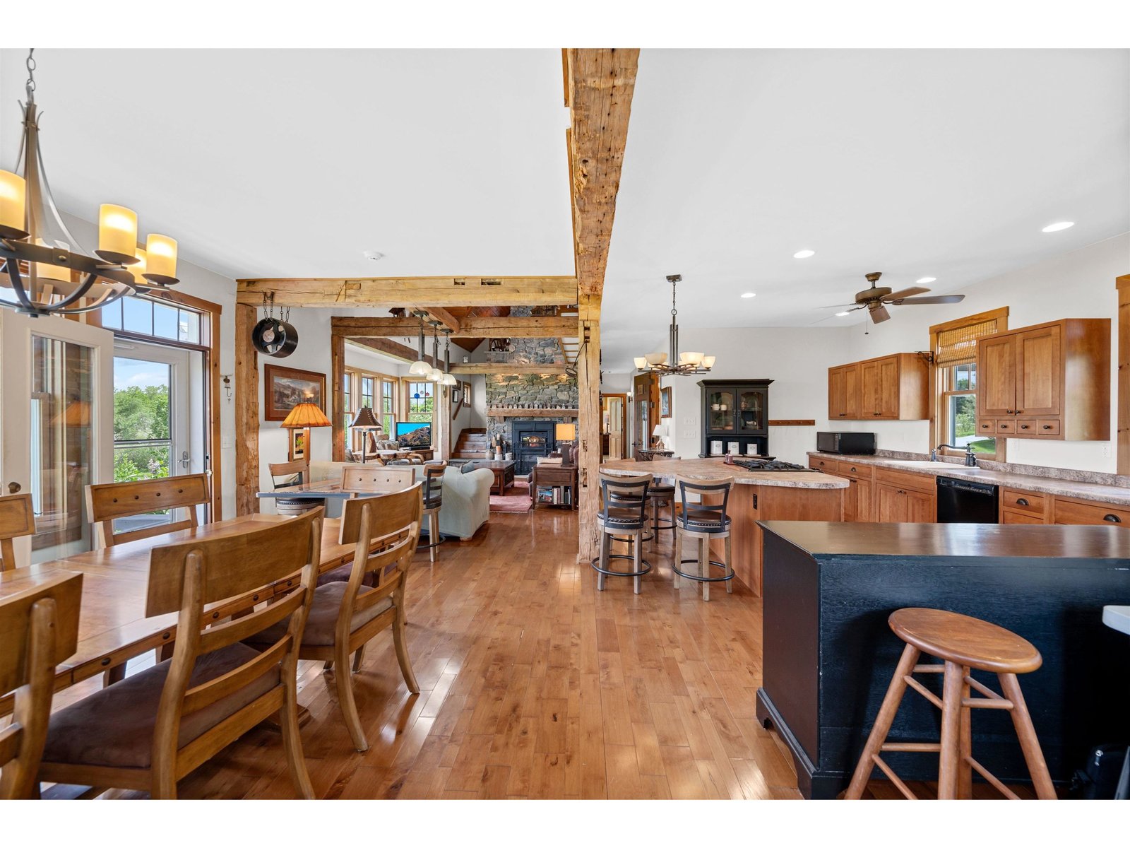 View of Great Room from gas stove to massive wood