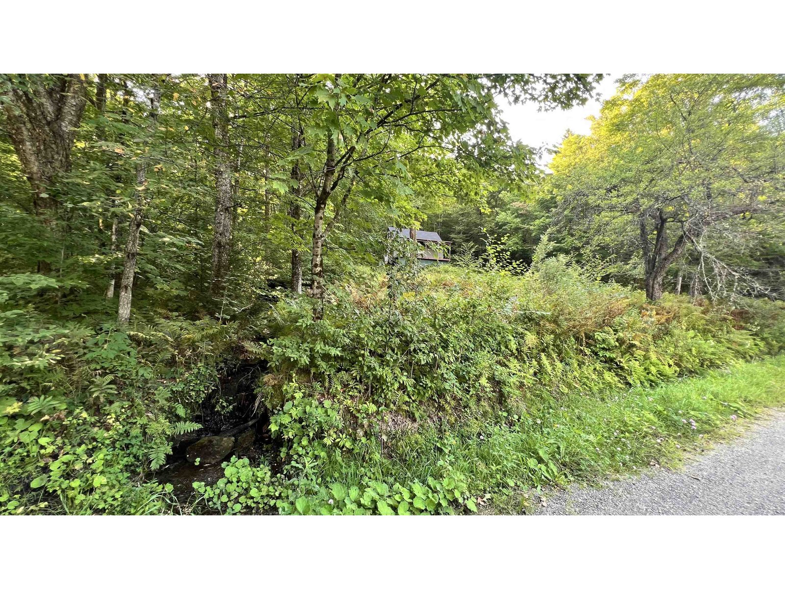 facing S: culverts for run-off direct to pond across road