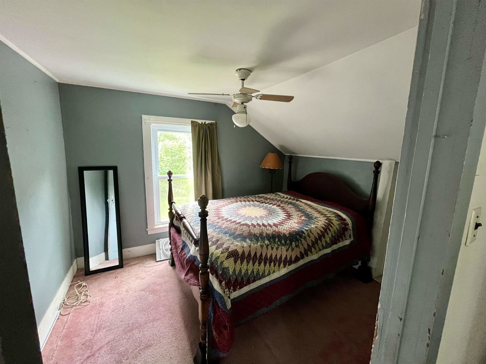 Bedroom 1 with entrance to walk in attic above kitchen