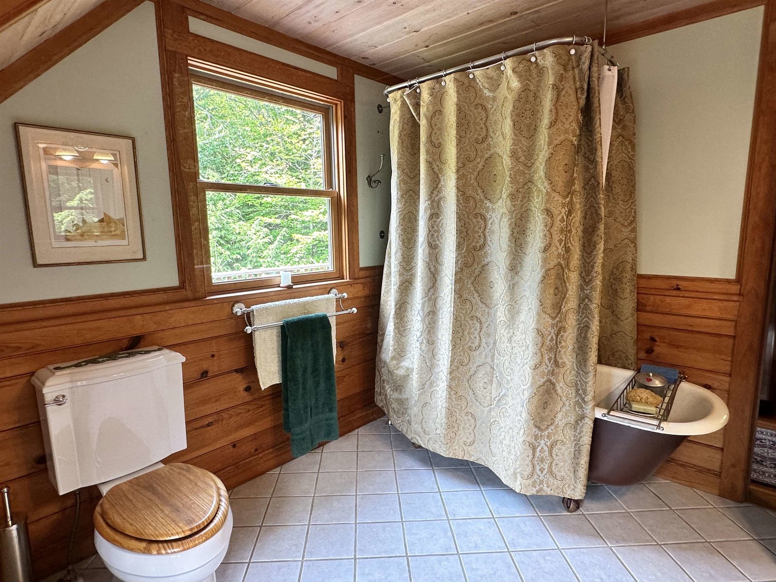 Old fashioned soaking tub with shower