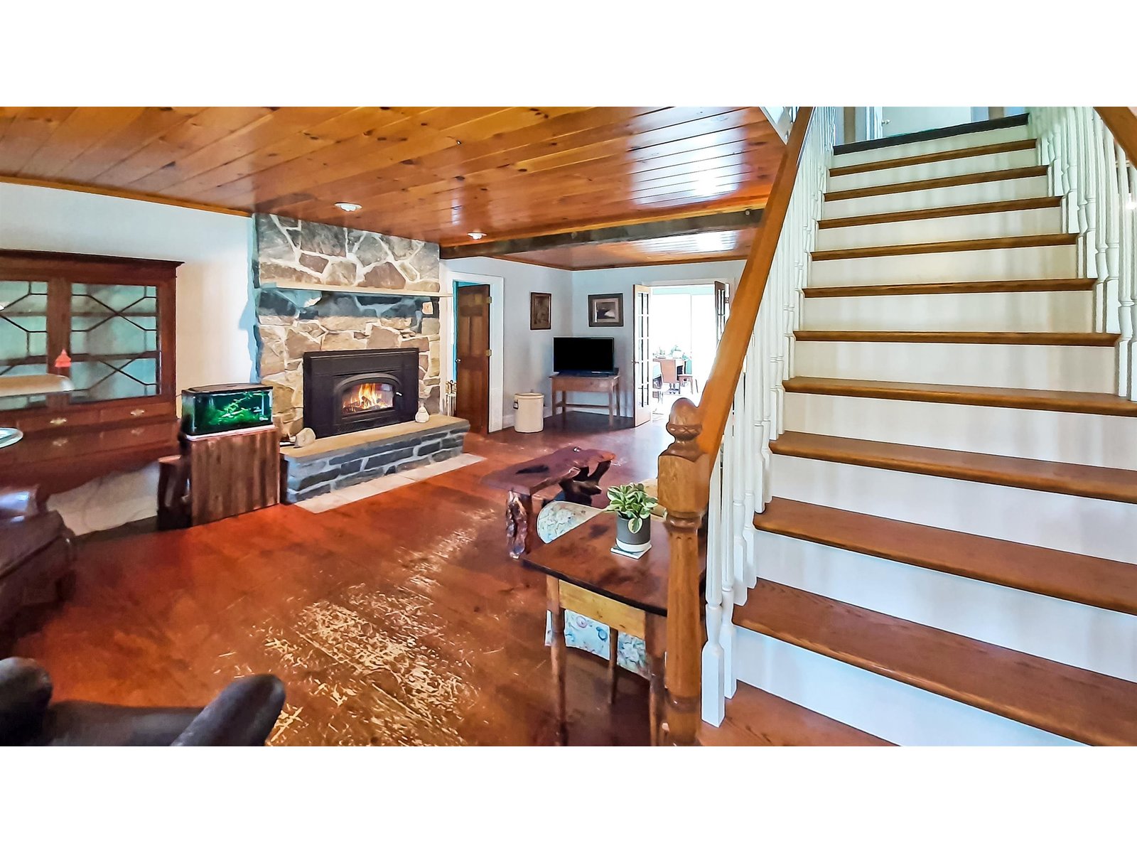 Entry Opens to Living Room with Stone Fireplace