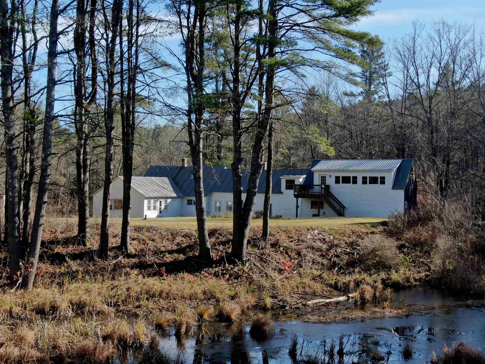 The house is set well back from the pond