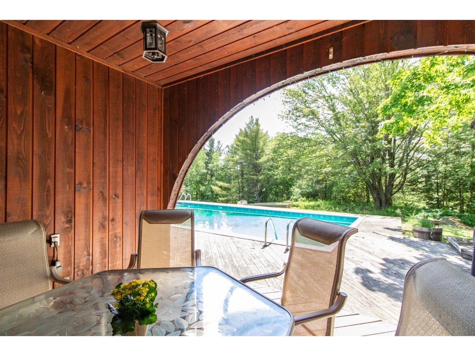 covered sitting area by pool