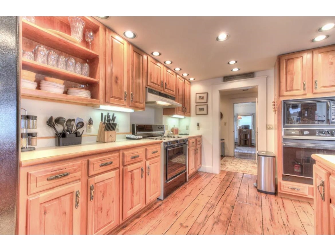 Kitchen looking in to a walk-in pantry