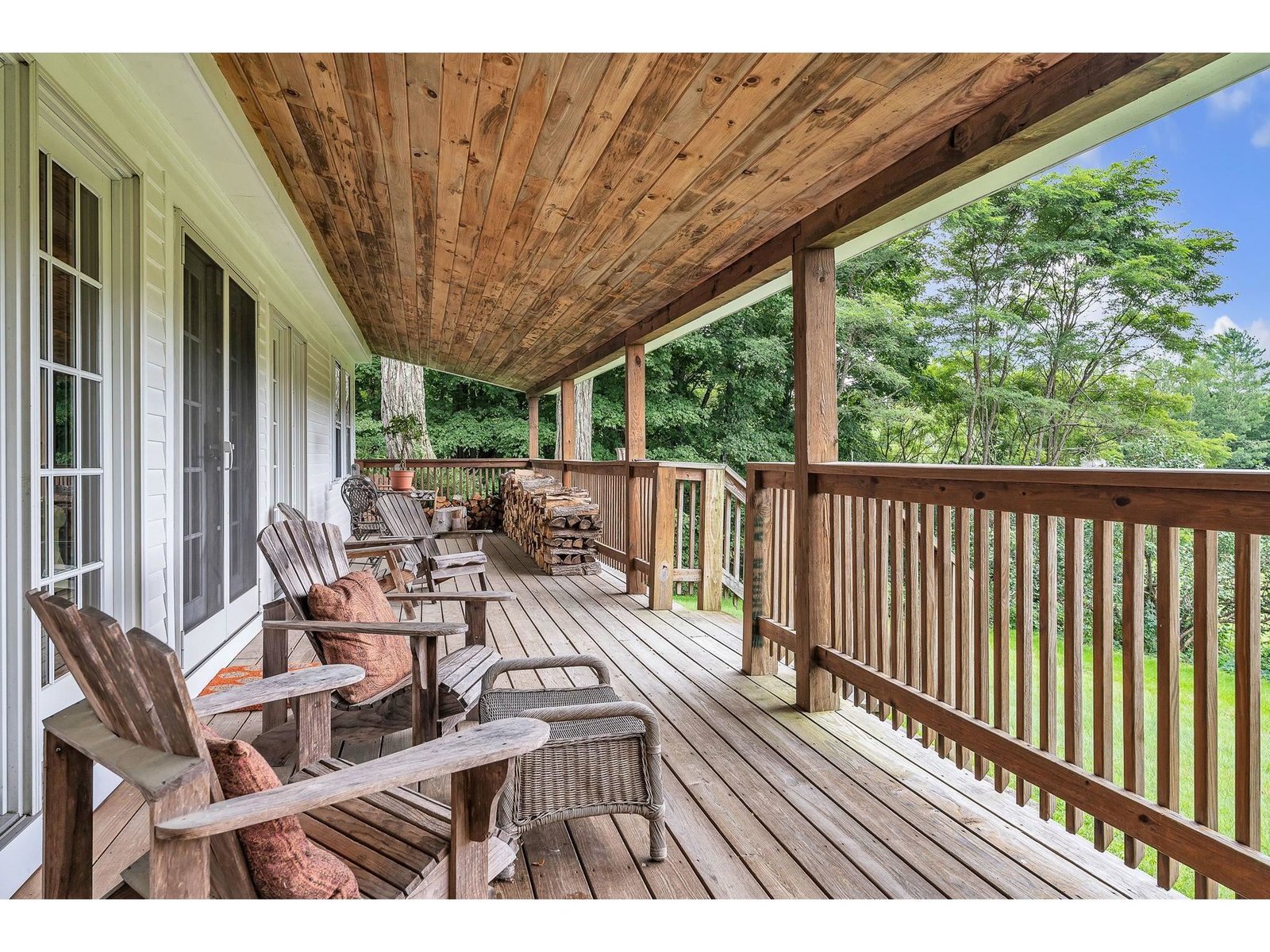 Gorgeous covered back porch overlooking the fields and Mtns