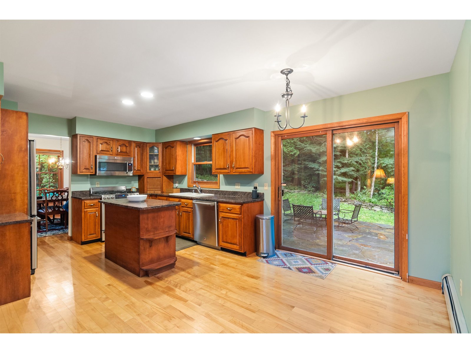 Spacious kitchen with granite counters and cherry wood cabinets