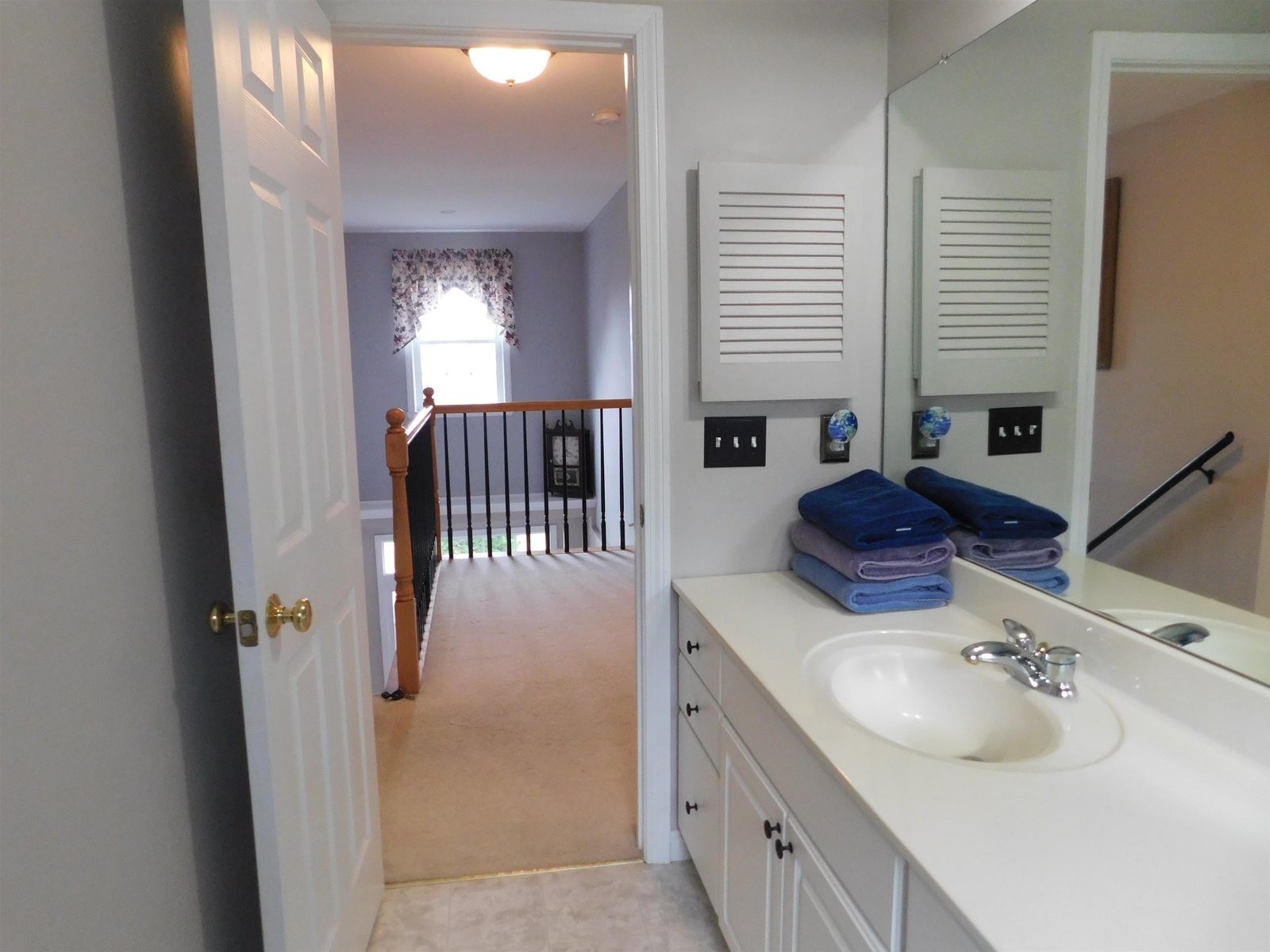 Hallway to access the laundry on the right, closet on the left and bonus room in the middle.