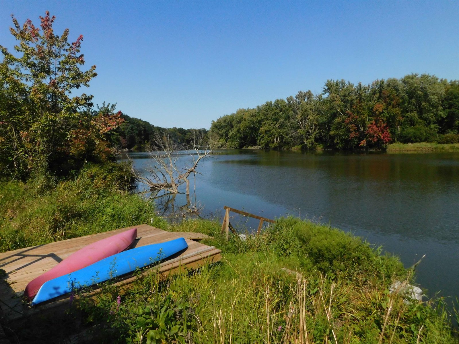 Riverside recreational deck and floating dock looking down the river..